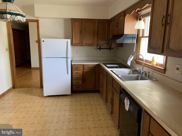 kitchen with white refrigerator, dishwasher, sink, and pendant lighting