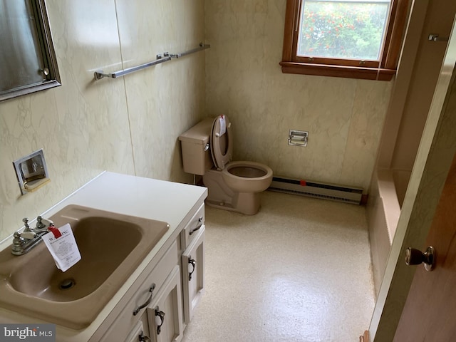 bathroom featuring vanity, a baseboard heating unit, and toilet