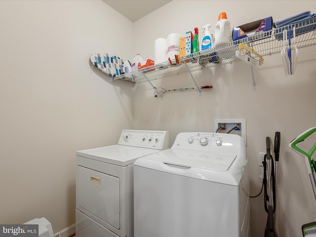 clothes washing area with washing machine and clothes dryer