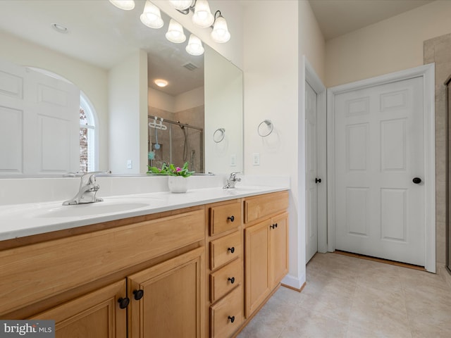 bathroom featuring walk in shower, tile patterned floors, and vanity