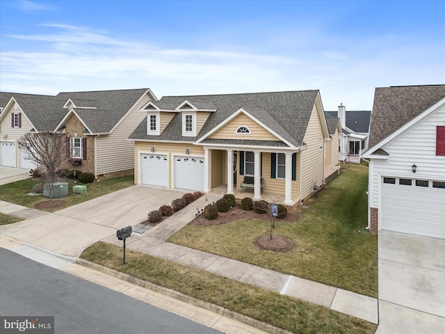 view of front of property with a garage, a front yard, and covered porch