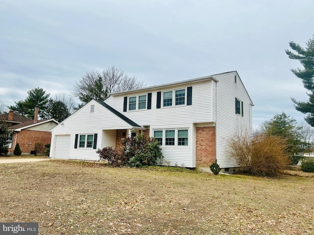 front of property featuring a garage and a front lawn