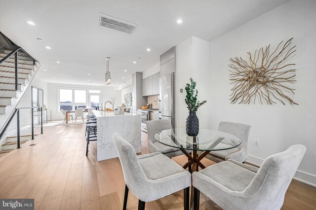 dining space featuring light wood-type flooring