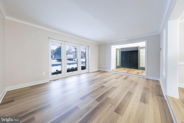 unfurnished living room with ornamental molding and light hardwood / wood-style floors