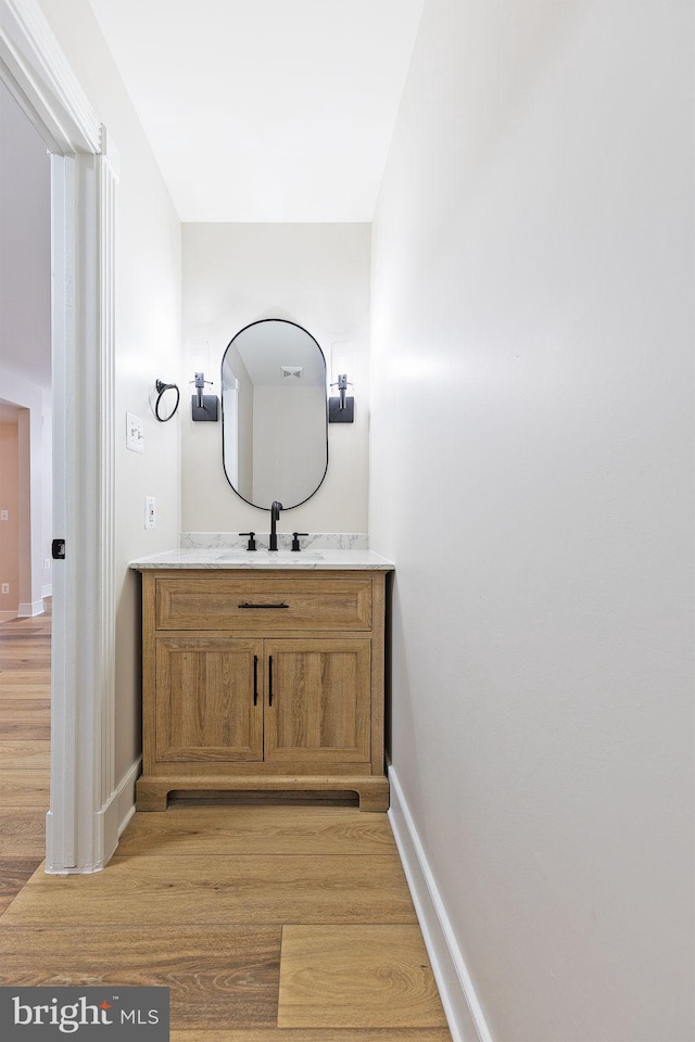 bathroom featuring vanity and hardwood / wood-style floors