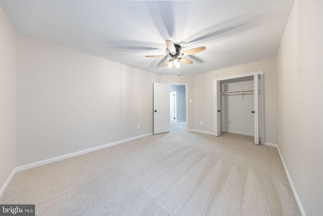 unfurnished bedroom featuring ceiling fan, a closet, and light carpet