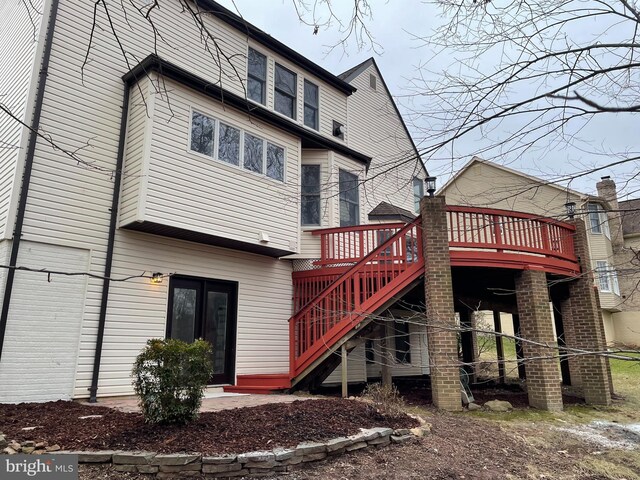 back of house featuring a wooden deck