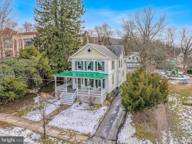 view of front of property with a playground and covered porch