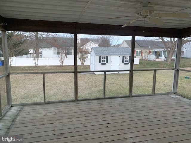 unfurnished sunroom with ceiling fan