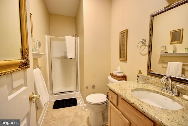 bathroom with vanity, tile patterned flooring, toilet, and walk in shower