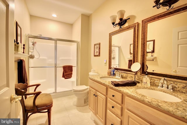 bathroom with vanity, tile patterned floors, toilet, and walk in shower