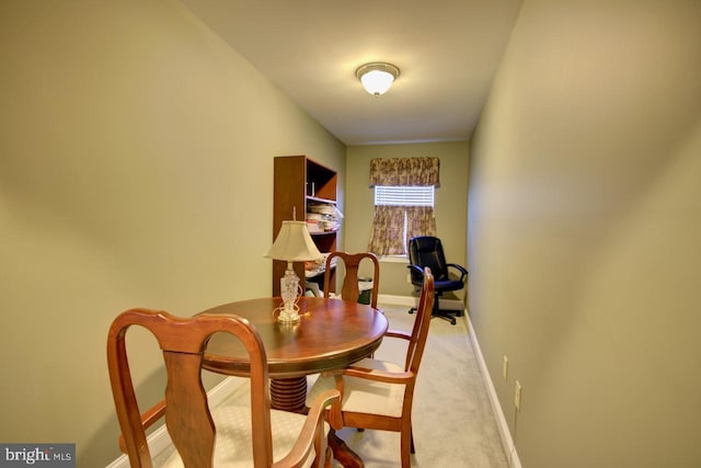 dining space featuring light colored carpet