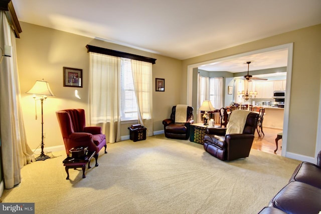 living room with light carpet and ceiling fan