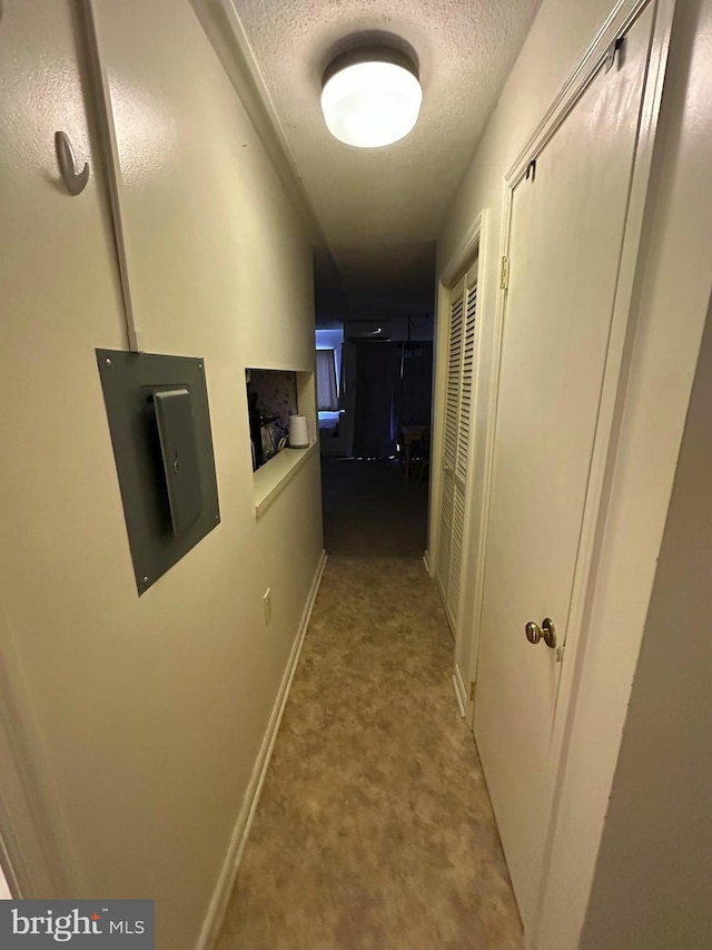 hallway featuring a textured ceiling