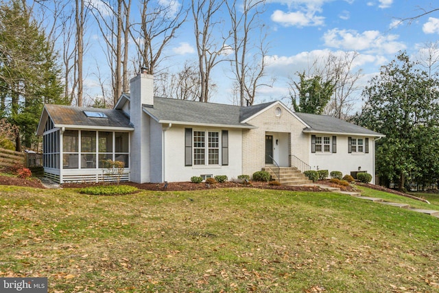 ranch-style home featuring a front lawn and a sunroom