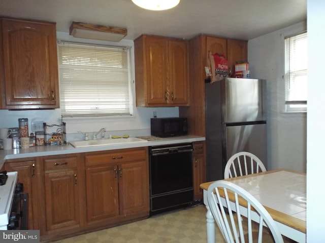 kitchen featuring sink and black appliances