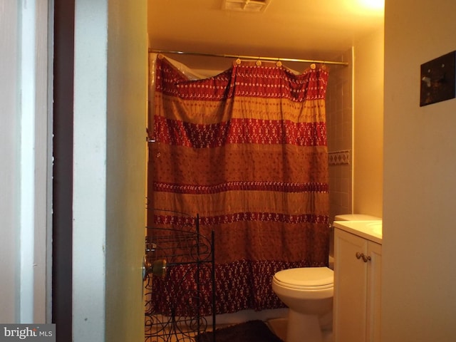 bathroom with vanity, a shower with shower curtain, and toilet