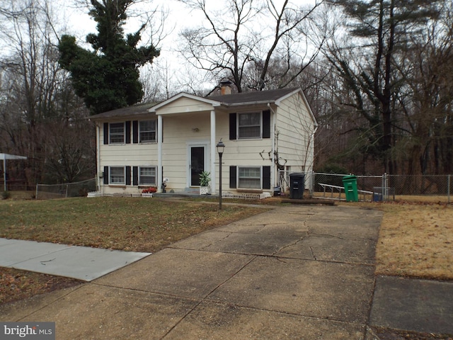 raised ranch featuring a front lawn