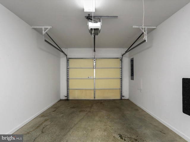 garage with a garage door opener and electric panel