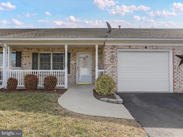 ranch-style home with a porch, a garage, and a front yard