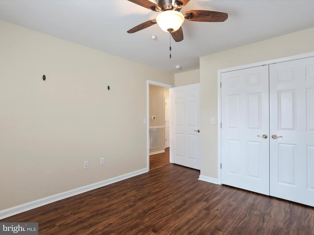 unfurnished bedroom featuring dark hardwood / wood-style flooring, a closet, and ceiling fan