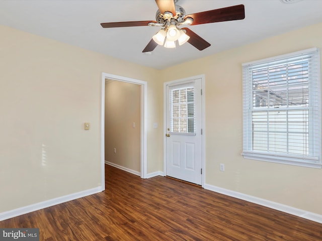 foyer entrance featuring dark wood-type flooring and ceiling fan