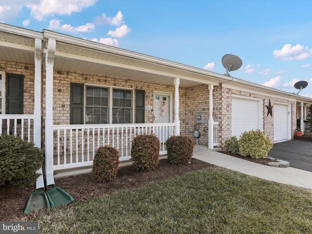 ranch-style home with a garage and a porch