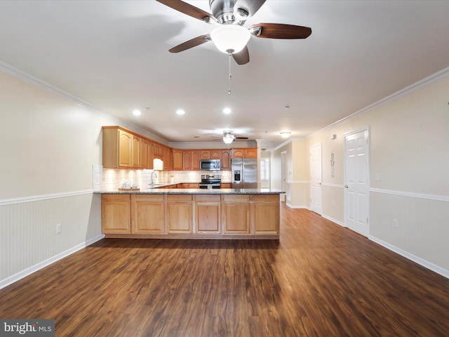 kitchen with stainless steel appliances, light stone countertops, dark hardwood / wood-style floors, and kitchen peninsula