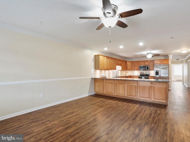 kitchen with dark hardwood / wood-style flooring, crown molding, kitchen peninsula, and appliances with stainless steel finishes