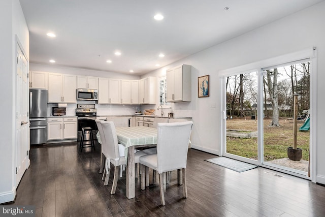 dining space with dark hardwood / wood-style flooring and sink