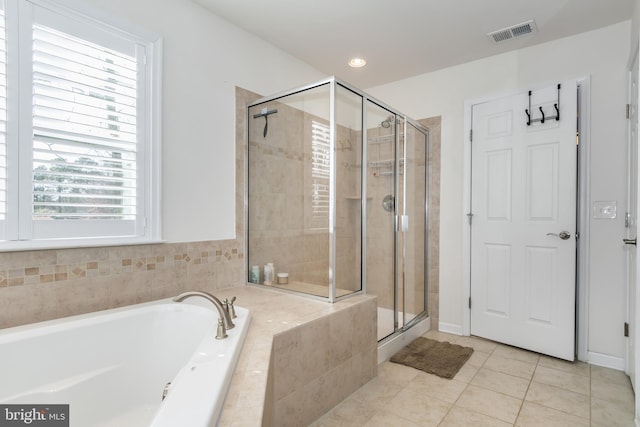 bathroom with tile patterned floors and plus walk in shower