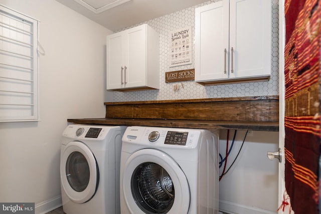 laundry room with cabinets and washer and dryer