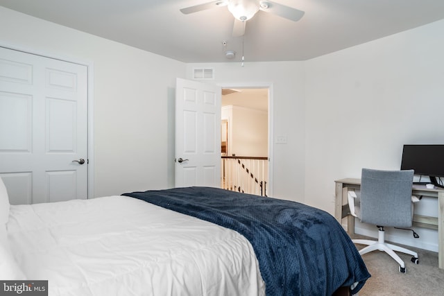 bedroom featuring ceiling fan and carpet