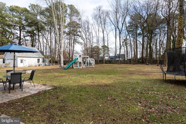 view of yard featuring a playground, a patio area, and a trampoline