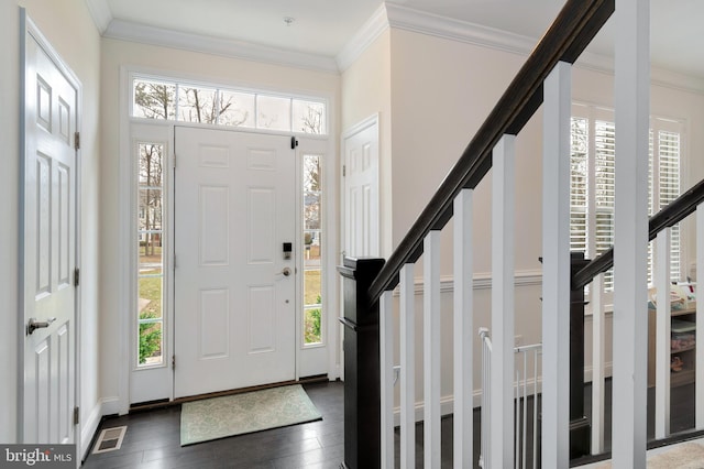 foyer entrance featuring crown molding and dark wood-type flooring