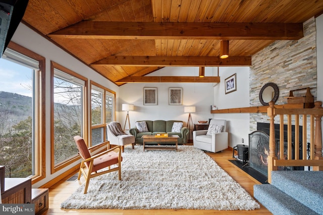 living room featuring vaulted ceiling with beams, wood ceiling, and light wood-type flooring