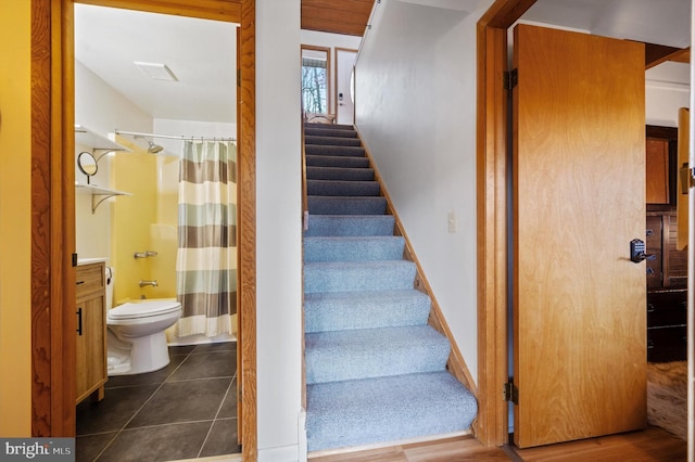 stairway with tile patterned flooring