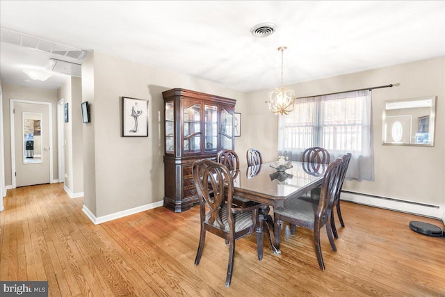 dining space featuring a notable chandelier, light wood-type flooring, and baseboard heating