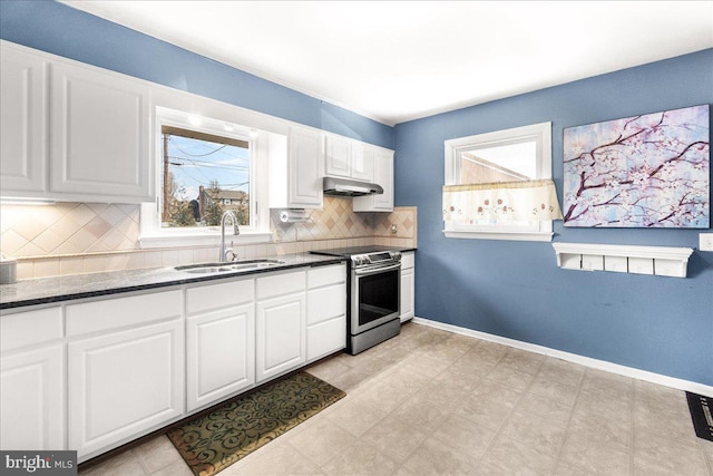 kitchen with tasteful backsplash, white cabinetry, sink, and stainless steel range with electric stovetop