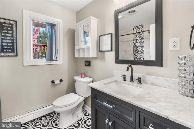 bathroom with vanity, toilet, and a baseboard heating unit