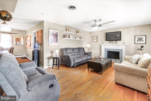 living room with ceiling fan and light wood-type flooring