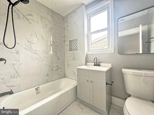 full bathroom featuring tiled shower / bath, vanity, and toilet