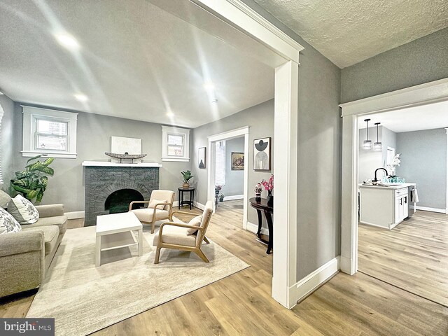 living room featuring light hardwood / wood-style flooring and a textured ceiling