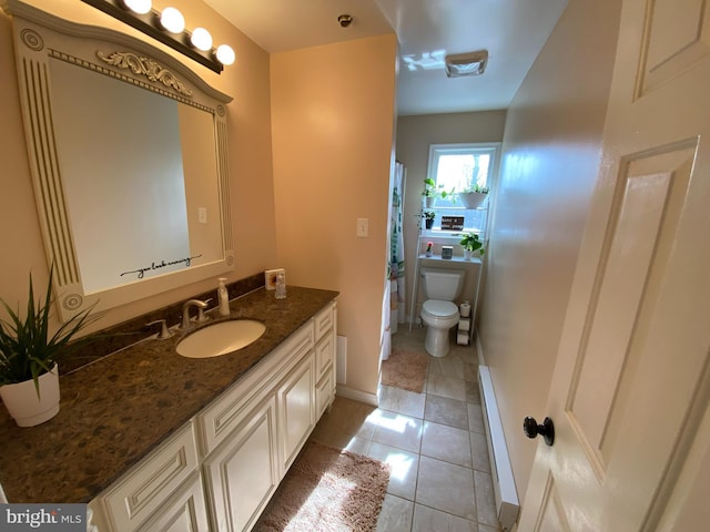 bathroom featuring vanity, tile patterned floors, and toilet