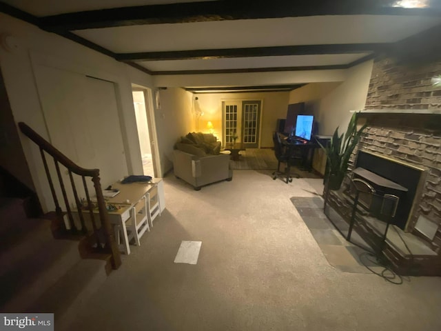 carpeted living room with beam ceiling