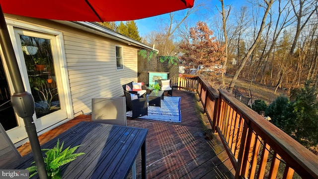 wooden deck with an outdoor living space