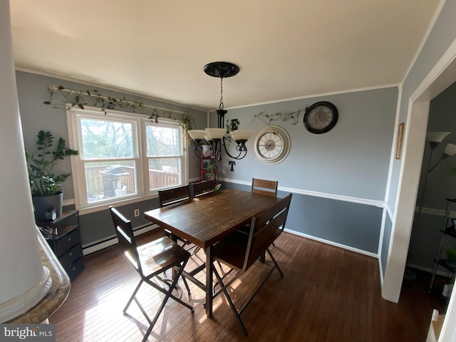 dining room with ornamental molding, dark hardwood / wood-style flooring, a baseboard heating unit, and a notable chandelier