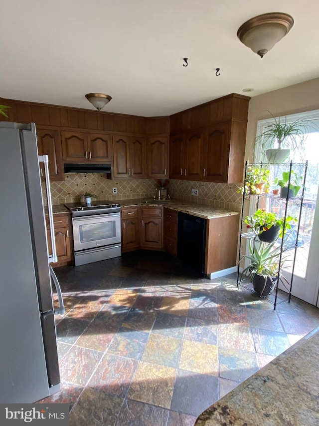 kitchen with stainless steel appliances and backsplash