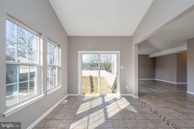 spare room featuring vaulted ceiling