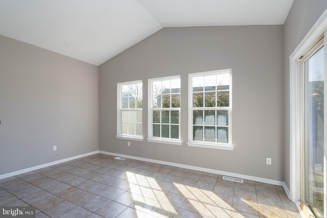 unfurnished room with vaulted ceiling